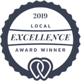 Local Excellence Award 2019 trophy displayed on a pedestal, symbolizing community achievement and recognition.